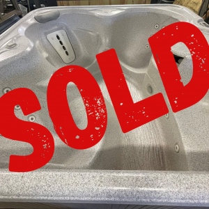 sold refurbs 35 | Young's Hot Tub Sales and Service Center Grey hot tub interior with built-in controls and multiple jets, partially covered by a large red SOLD stamp.