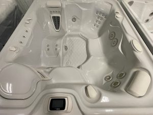 r408 2 | Young's Hot Tub Sales and Service Center A white spa hot tub interior with multiple jet clusters, built-in seats, and a central control panel labeled HotSpring at the bottom.