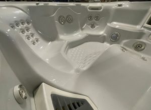 r408 6 | Young's Hot Tub Sales and Service Center Indoor hot tub with multiple mounted jets and a built-in stepped seating area