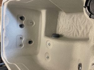 r442 4 | Young's Hot Tub Sales and Service Center Inside of a hot tub with multiple jet nozzles along the wall and a drain in the basin center