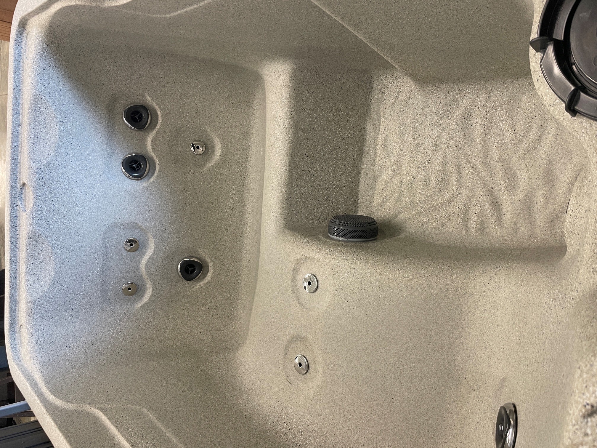 r442 4 | Young's Hot Tub Sales and Service Center Inside of a hot tub with multiple jet nozzles along the wall and a drain in the basin center