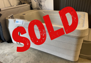 sold refurbs 41 | Young's Hot Tub Sales and Service Center Gray hot tub on a showroom floor with a large red SOLD overlay across it.